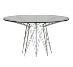 a round glass table with metal legs