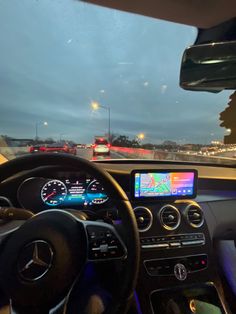 the dashboard of a car on a highway at night