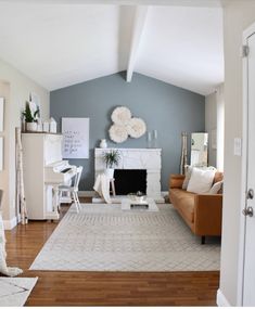 a living room filled with furniture and a fire place in the middle of a room