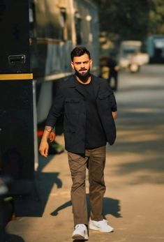 a man with a beard walking down the street