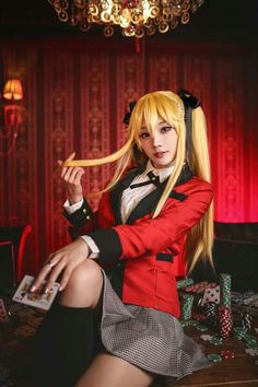 a woman with long blonde hair sitting on top of a table