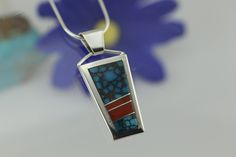 "This contemporary pendant is from our collection of Navajo Native American jewelry and handmade in sterling silver. It is an inlay style pendant with natural Turquoise and Coral Navajos are pioneers of silversmithing since the 1850's. Their jewelry is highly regarded because of its unique style and beauty. Traditionally, silver represents the main visual element and stones are considered accents for silver work. Contemporary designs enhance the stones and silver depending on the style, skill an Southwestern Turquoise Inlay Pendant Necklace, Unique Sterling Silver Turquoise Inlay Necklace, Gift Turquoise Necklace With Sterling Silver Inlay, Inlay Jewelry, Natural Turquoise Stone, Turquoise And Coral, Sky Design, Bird Pendant, Contemporary Pendant