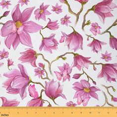 pink flowers are painted on white fabric with green stems and yellow centers, along with a ruler