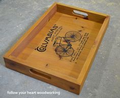 a wooden tray with an image of a bicycle on the side and words gumpwaps