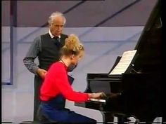 a man and woman are playing the piano