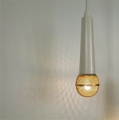 a light fixture hanging from the ceiling in a room with white walls and flooring