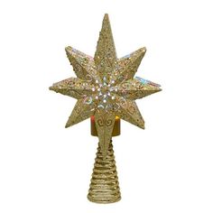 a gold christmas tree topper with an intricate star design on the front and sides