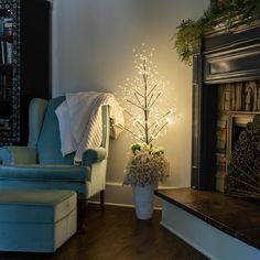 LED fairy light trees placed in a vase on the floor create the coziest reading nook! Lighted Branches Decor, Reading Nook Light, Viking Christmas, Library Bedroom