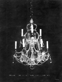 an old chandelier hanging from the ceiling