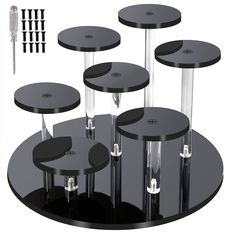 four black tables with metal bases and screws on each one side, all in different sizes