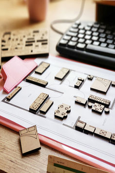 several wooden pieces are arranged on a table next to a keyboard and calculator