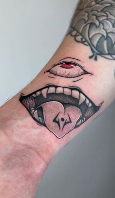 a person's hand with a tattoo on it and an open mouth in the middle