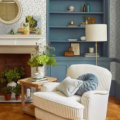 a living room filled with furniture and a fire place next to a wall mounted book shelf