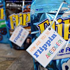 there are bags of chips for sale on the street in front of some other packages