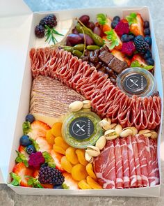 a box filled with assorted meats and fruit