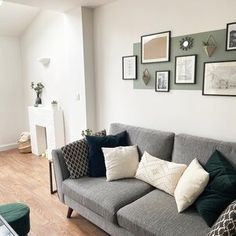 a living room filled with lots of furniture and pictures on the wall above it's couch