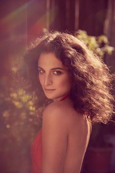 a woman in a red dress posing for a photo