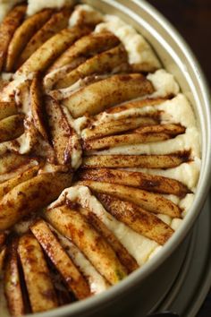 an apple pie with cinnamon on top is in a pan and ready to be eaten