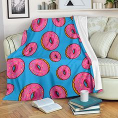 a couch covered in a pink and blue donut pattern with sprinkles