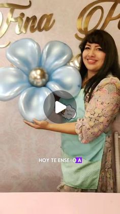 a woman is holding balloons in front of a sign that says, fija do