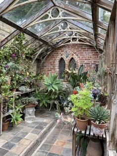 the inside of a greenhouse with lots of potted plants