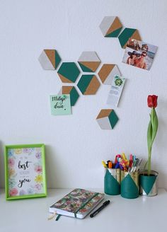 a white desk topped with lots of pictures and writing utensils on top of it