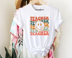 "Retro Teacher Shirt for Teacher, Unisex Teacher Tee for Women, Back to School Teaching Shirt, Teacher Appreciation Gifts for Teacher 💙HOW TO ORDER💙 1- In each of our listings, you can find charts where you can examine body measurements and color variations. 2- Choose your size and clothing color from the scroll down menus. 3- Select quantity and click the \"Add to cart\" button. 4- If you want to buy multiple shirts in different sizes and colors, you can add each one to the cart separately and buy them in bulk. 5- Feel free to contact us about anything. 💙OUR PRODUCTS AND PRINTING💙 - All our shirts are very soft. It is durable enough to use and wear for a long time. Perfect for gifting to your loved ones on special occasions. - Before purchasing, you can take a look at the reviews left Gifts For Teacher, Women Back, Teaching Shirts, Teacher Tees, Tees For Women, Appreciation Gifts, Teacher Appreciation Gifts, Teacher Shirts, Teacher Appreciation