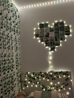 a bedroom decorated with green leaves and string lights