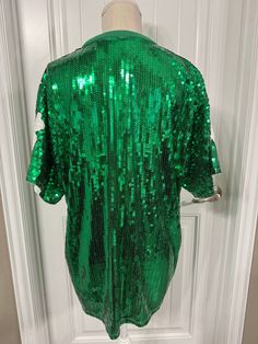 SIZE: One Size Fits Most (comfortably fits up to 1XL)Length (top to bottom) - 31 inchesBust - 23 inches across Sleeve width - 10 inches widede Green Sequined Short Sleeve Tops, Green Stretch Sequined Tops, Green Sequined Stretch Tops, Green Sequined Tops For Spring, Fitted Green Top For Party Season, Fitted Green Tops For Party Season, Casual Green Shirt For Party, Green Long Sleeve Sequin Top, Green Sequin Tops For Fall