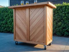 a wooden cart with two wine glasses on top