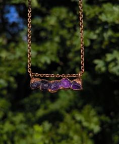 Great necklace with five raw amethyst crystals, which were set in copper using electroforming. The copper was then polished and sealed to prevent potential oxidation and discoloration. Width of pendant: 4.3 cm Length of pendant: 1.5 cm Each piece of jewelry is made by me with love and care in my small studio and is therefore unique. Each piece of jewelry is shipped in environmentally friendly gift packaging. Amethyst Raw Stone Necklace For Healing, Purple Raw Stone Necklace For Gift, Amethyst Pendant Necklace With Raw Stone, Electroformed Amethyst Crystal Necklace As Gift, Purple Amethyst Necklace With Raw Stone, Purple Raw Stone Crystal Pendant Necklace, Amethyst Raw Stone Pendant Necklace, Hand Forged Amethyst Pendant Necklace, Purple Raw Stone Necklaces For Healing