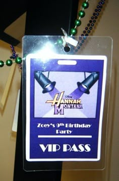 a purple and white tag with green beads on it that says happy birthday party vid pass