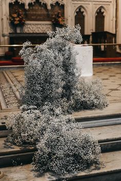 an old church with pews and flowers on the ground in front of it's alter