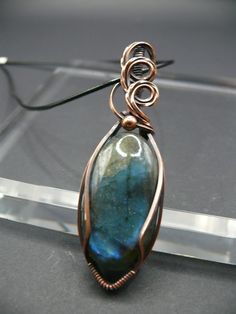 Handmade wire wrapped labradorite gemstone pendant. Labradorite is known for its captivating play of colour, shifting hues from blues and greens to flashes of gold.  Labradorite activates intuition, wisdom, clarity, creativity, and divination it helps to recognize positivity and hope. Each pendant is a one-of-a-kind piece of wearable art, making it the perfect statement accessory for those who appreciate the extraordinary.  This beautiful gemstone is wrapped in oxidized copper to give it a vinta Wire Wrapped Labradorite Teardrop Pendant Necklace, Wire Wrapped Labradorite Oval Pendant Jewelry, Wire Wrapped Labradorite Oval Pendant Necklace, Green Labradorite Wire Wrapped Jewelry, Simple Wire Wrapped Pendant, Wire Wrapped Pendant Tutorial, Copper Jewellery, Wire Wrapped Jewelry Diy, Pendant Tutorial