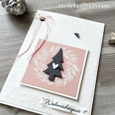 a card with a christmas tree on it and some other decorations around the card,