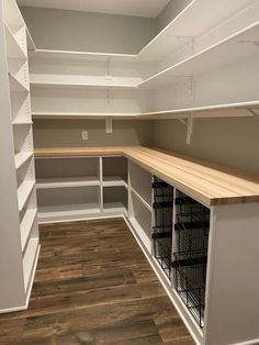 an empty walk in closet with lots of shelves