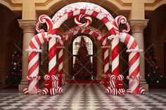 an archway decorated with candy canes and christmas decorations