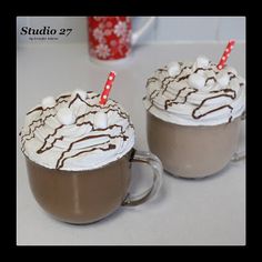 two cups filled with hot chocolate and marshmallows