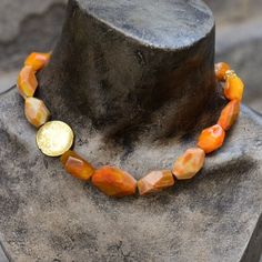 "This is a stunning statement necklace. Orange agate druzy nugget stones create a very unique piece. A gold plated coin bead is placed on one side to give an asymmetric modern look. This necklace will work for everyday or with an evening dress. Dimensions: length - 19\" (including clasp) extender- can be added by request *If, for any reason, you are not completely satisfied, please contact me so we can try to work out the problem. Shipping I ship twice a week. pls allow few days before shipping. Wide Silver Ring, Red Coral Necklace, Stone Statement Necklace, Orange Agate, Sterling Silver Wedding Rings, Druzy Necklace, Coral Stone, Silver Wedding Rings, Necklace Beaded