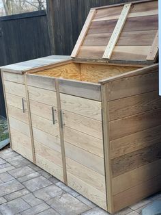 a large wooden box sitting on top of a brick floor