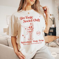 Embrace our Gin Tonic shirt! This tee is perfect for anyone who loves cocktails or appreciates aesthetic shirts! Treat yourself or surprise a friend with this thoughtful gift!  👕 COMFORT COLORS 1717 T-SHIRT The Comfort Colors 1717 garment-dyed unisex t-shirt is made with medium fabric consisting of high quality, 100% ring-spun US cotton for long-lasting comfort. All shirts feature pre-shrunk cotton for size retention and a signature sewn-in twill label. 👕 SIZING & CARE Shirt runs true to size. Gin Tonic Cocktail, Tonic Cocktails, Bachelorette Merch, Cocktail Club, Day Drinking, Club T Shirt, Gin Tonic, Aesthetic Shirts, Club Shirts