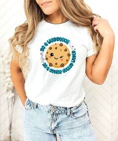 a woman wearing a white shirt with a cookie on it