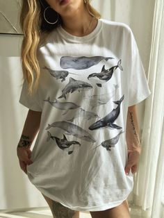 This is the Unisex-Style Whale and Sea Star Tee. It is a super cool, heavy cotton tee with watercolor whales design. This classic T is made with cotton, sometimes polyester (depending on the color) and has no uncomfortable side seams. Perfect for whale and ocean lovers! This design is an original, created by Jillian Anderson @ A Living Whimsy. She uses digital graphic design elements and collage and optimizes each image or illustration for a crisp, clear, and gorgeous print onto a variety of app Whale Watching Outfit, Jillian Anderson, Indie Clothes Aesthetic, Watercolor Whales, Clothes Alt, Indie T Shirts, Ocean Outfits, Ocean Shirt, Alt Clothing