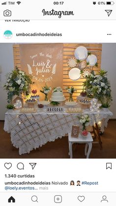 the table is decorated with white flowers and greenery for an elegant wedding reception at instagram