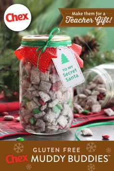 a jar filled with muddy buddies on top of a table next to other christmas decorations