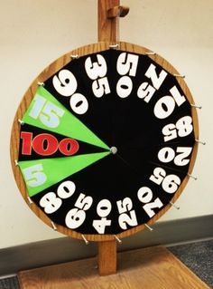 a wooden clock with numbers and arrows on it