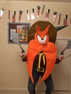 a man in an orange costume holding scissors