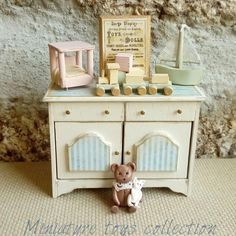 a teddy bear sitting in front of a dresser