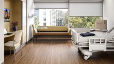 a hospital room with wooden floors and white furniture