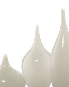 three white vases sitting next to each other